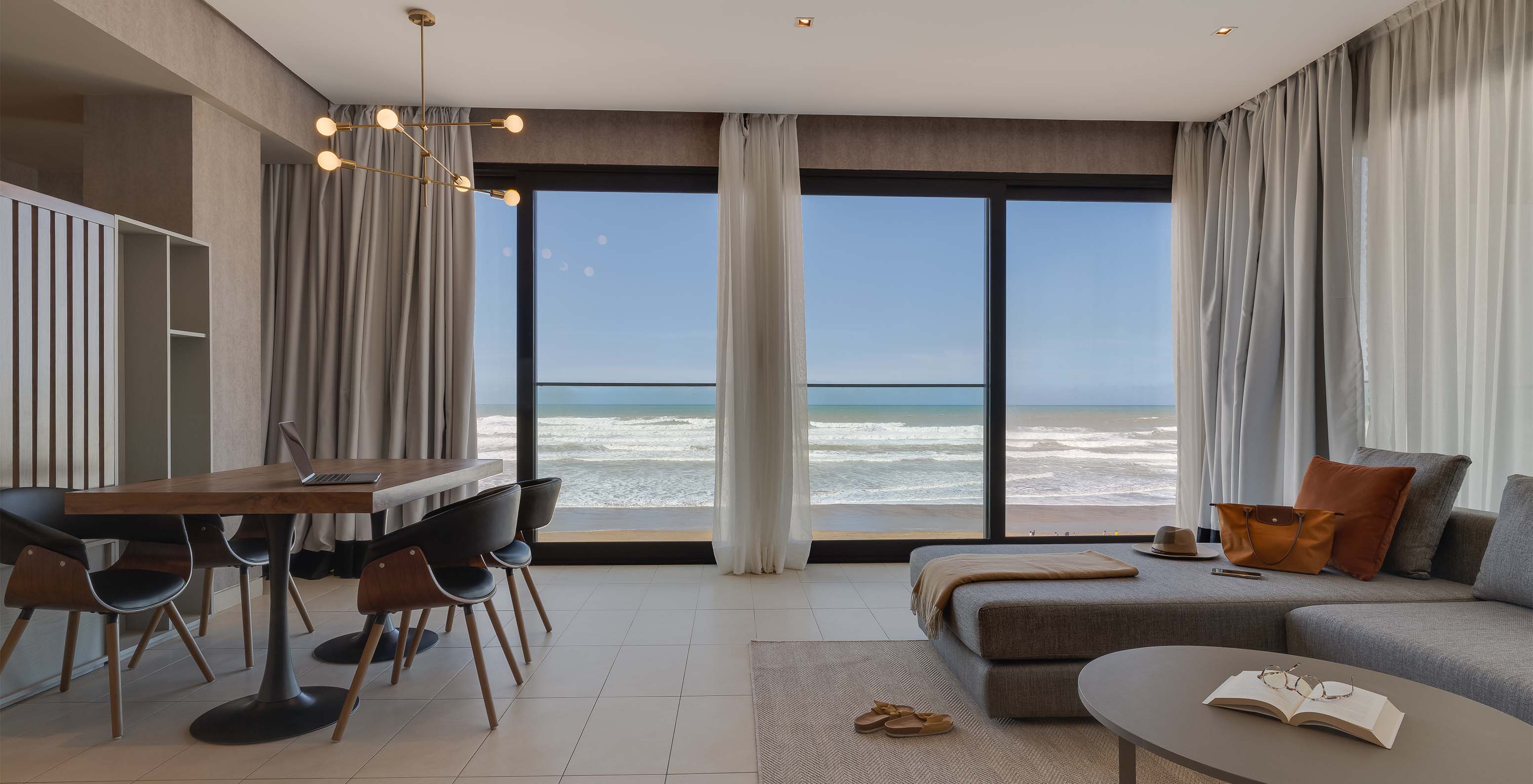The Family Corniche Suite at Pestana Casablanca has a living room with a sofa and spectacular beach views