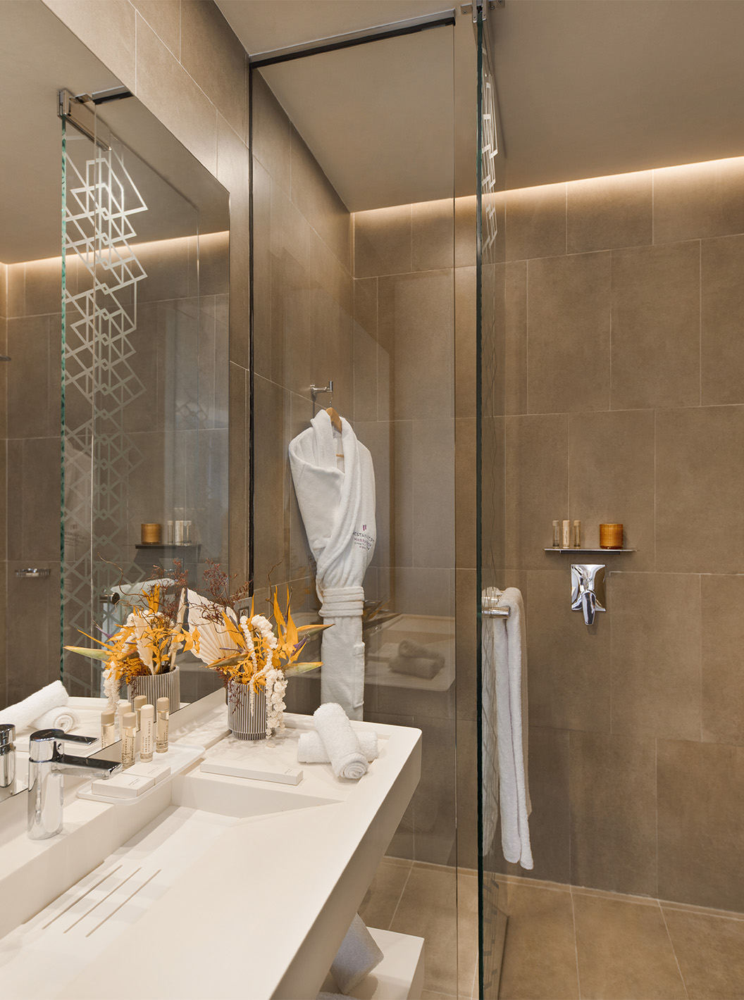 The CR7 Room Avenue at Pestana CR7 Marrakech has a bathroom with a walk-in shower, sink with mirror, and various amenities