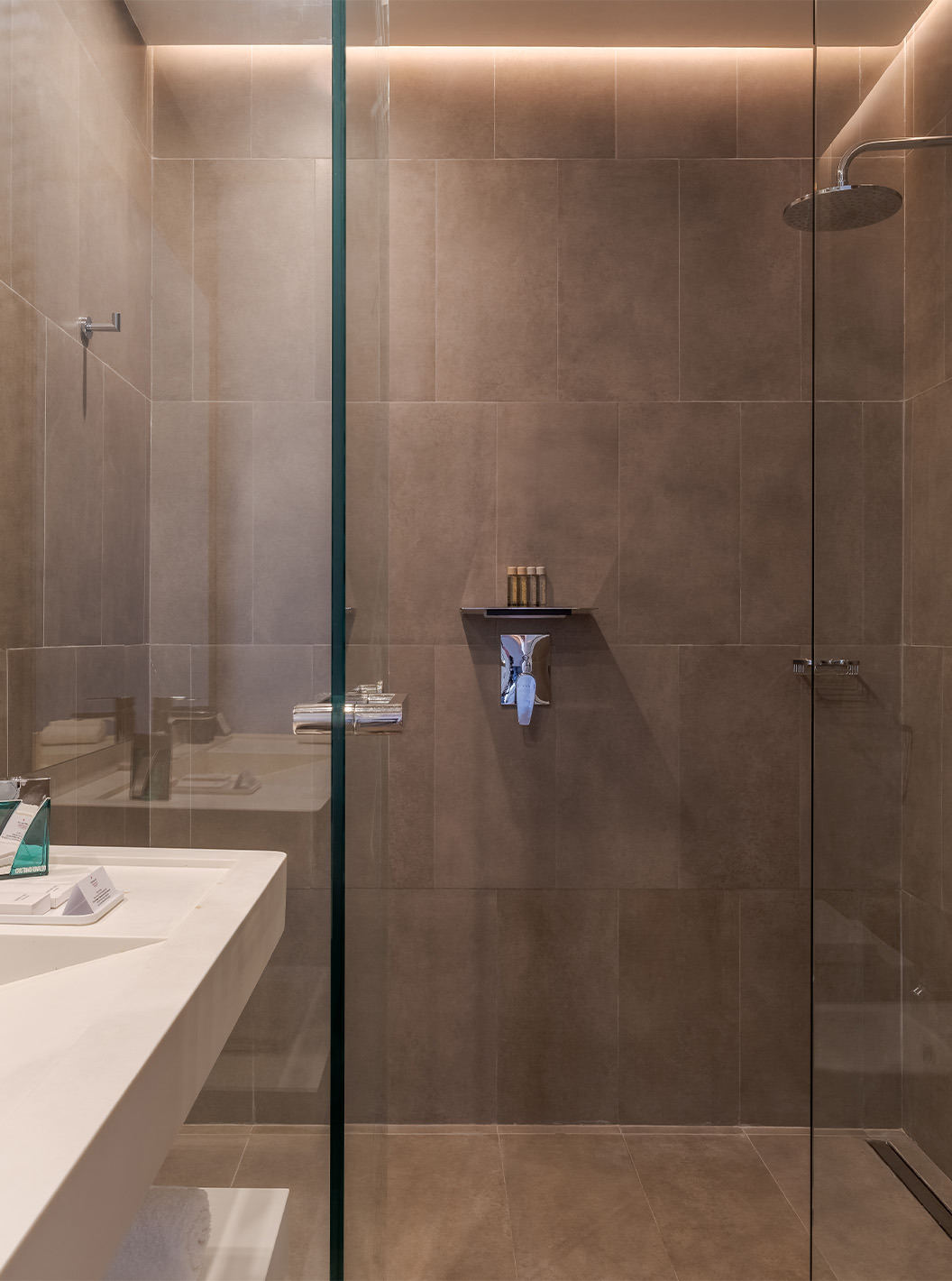 The CR7 Superior at Pestana CR7 Marrakech has a bathroom with a walk-in shower and a sink with a large mirror