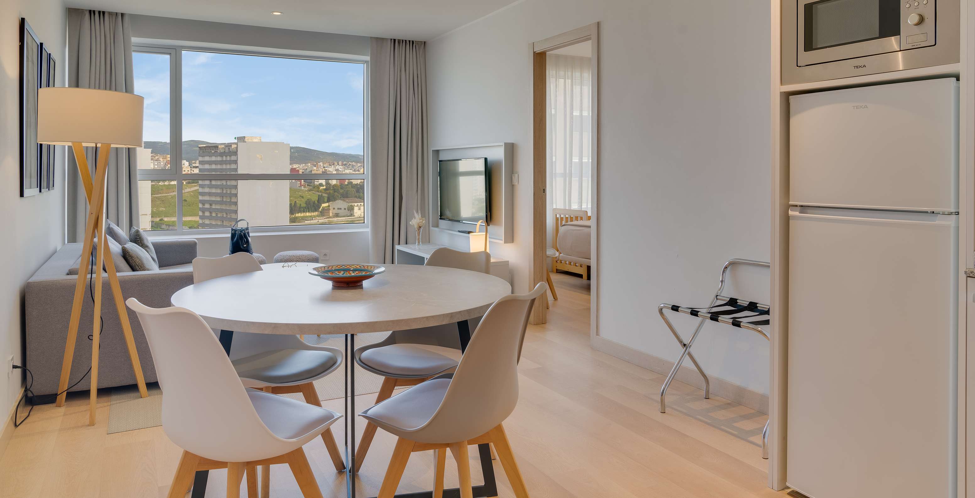 The Suite of Pestana Tanger City Center features a kitchen with refrigerator, microwave, and a dining table