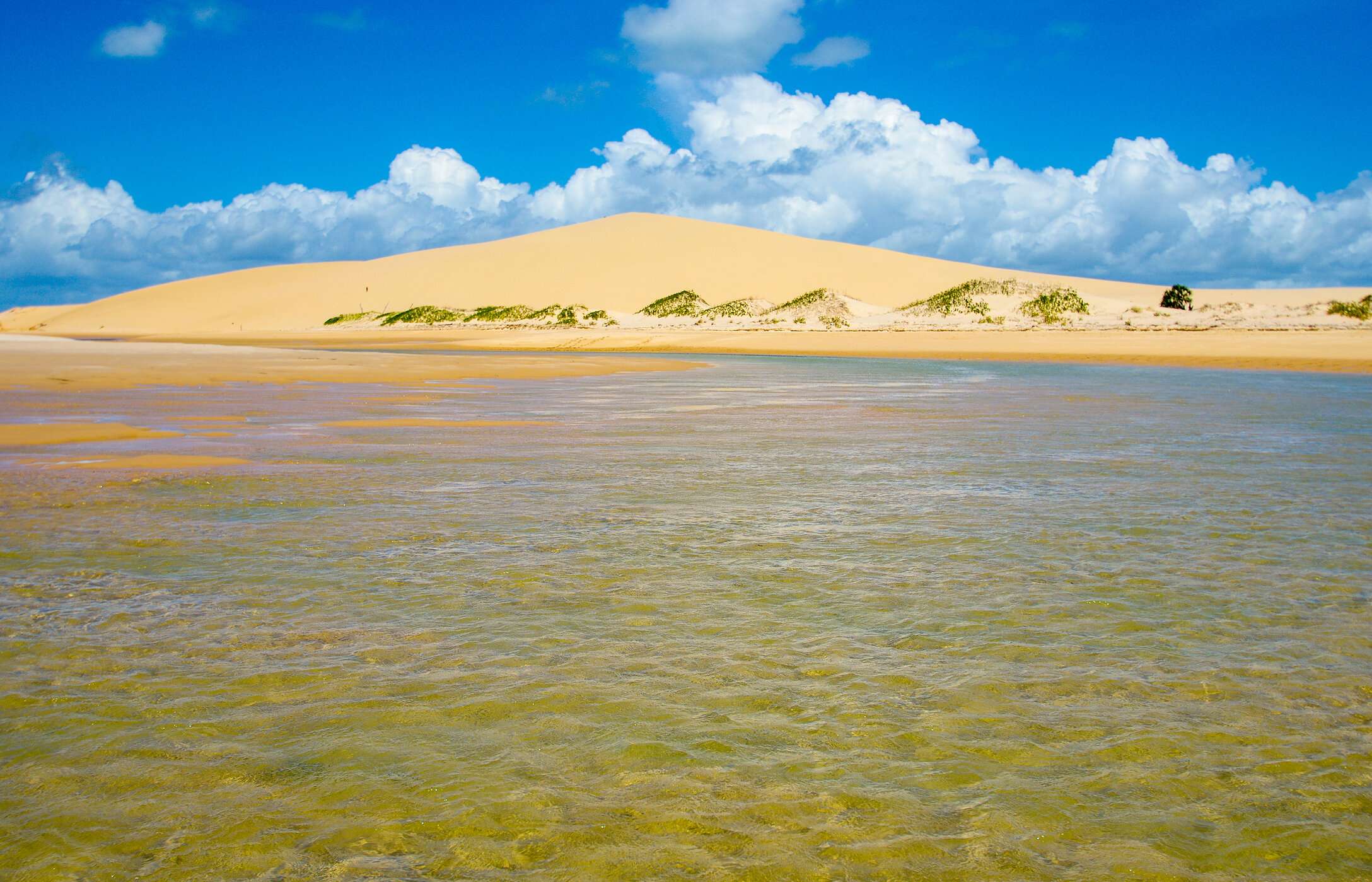 Panoramic view of the golden sand dunes of Bazaruto National Park, with a crystal-clear lagoon