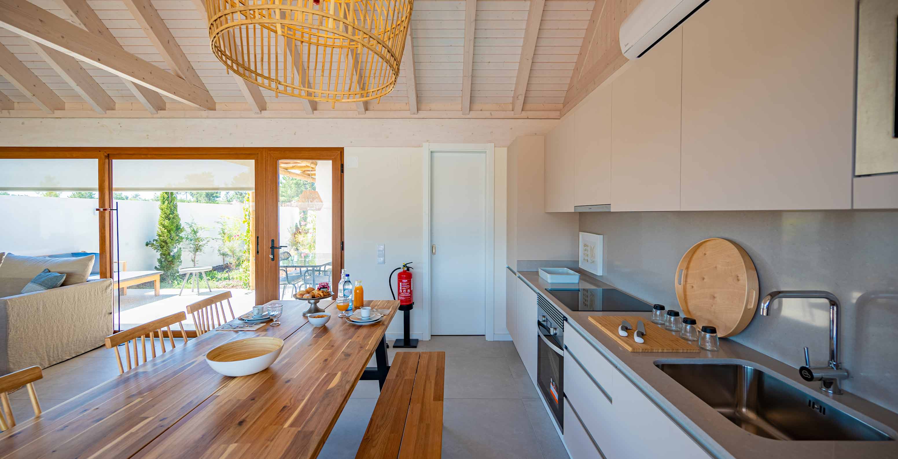 The Standard Green Villa at Pestana Comporta Village Residences has a modern kitchen with a wooden table and an oven