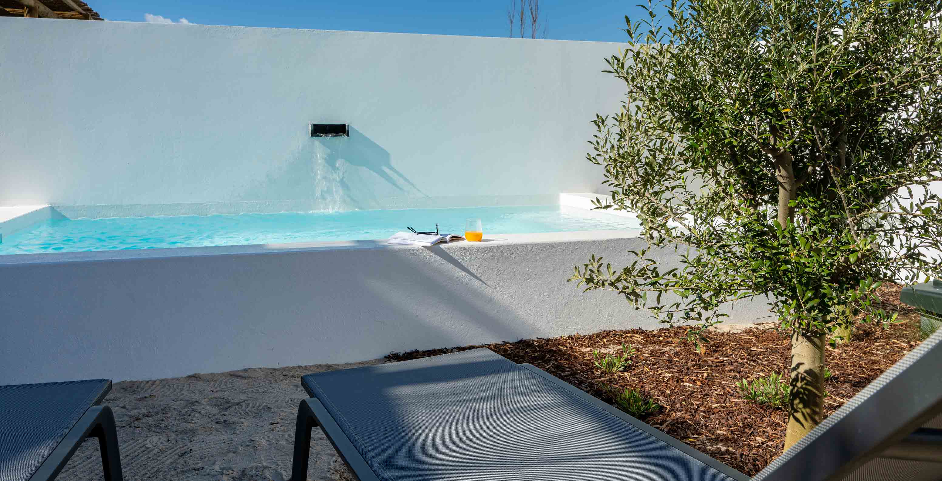 The Superior Villa at Pestana Comporta Village Residences has a pool with a waterfall and several sun loungers