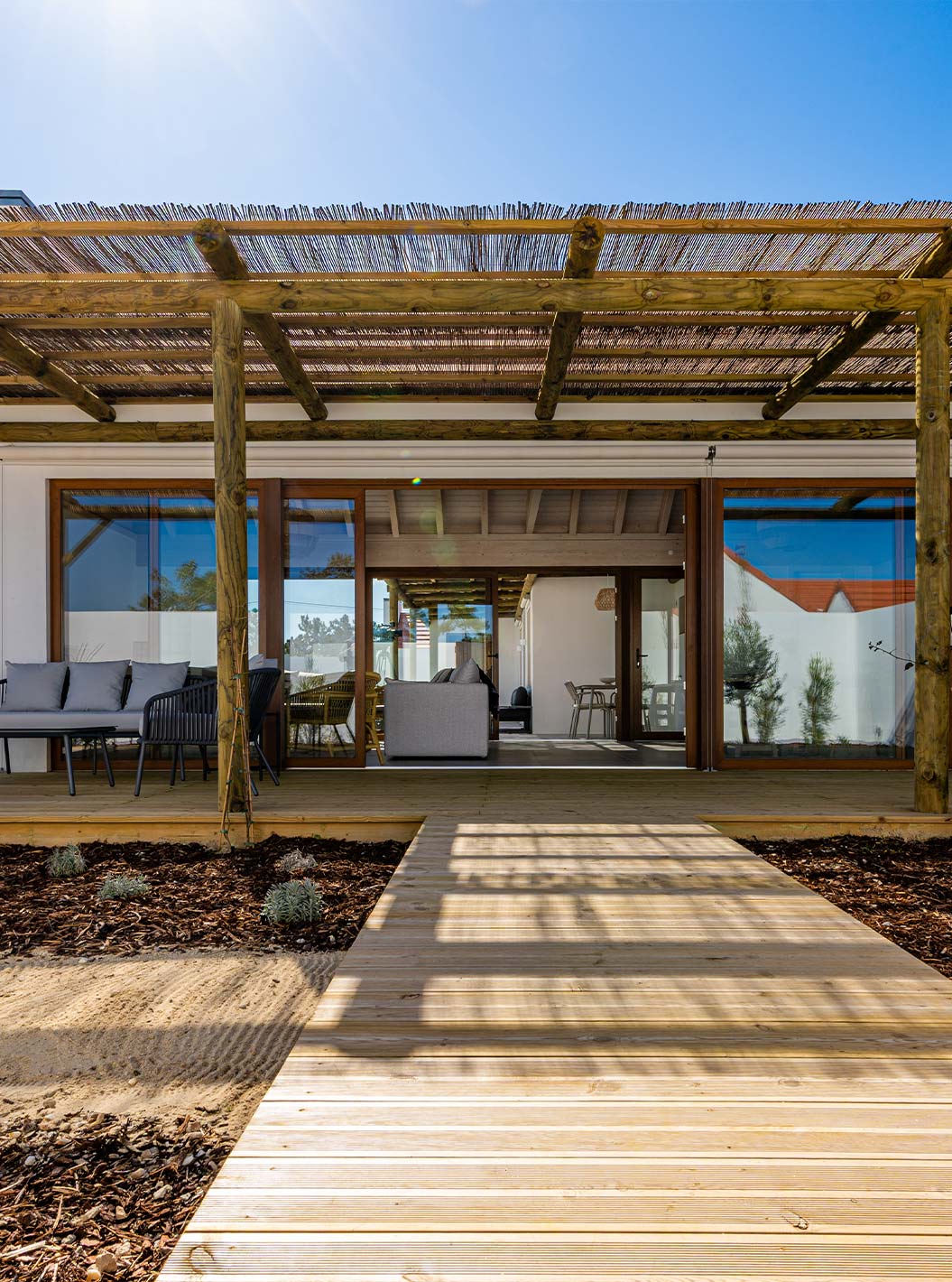 The Premium Villa at Pestana Comporta Village Residences has an entrance with a wooden deck, a pergola, and a garden