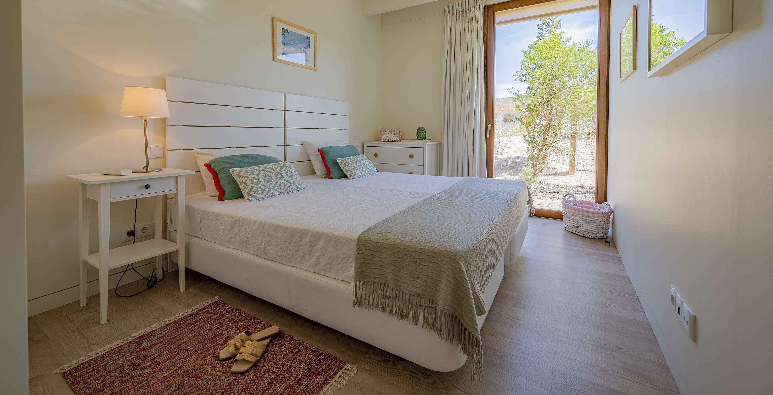 The Aqua Villa of Pestana Tróia Eco Resort has a double bed and a floor-to-ceiling window