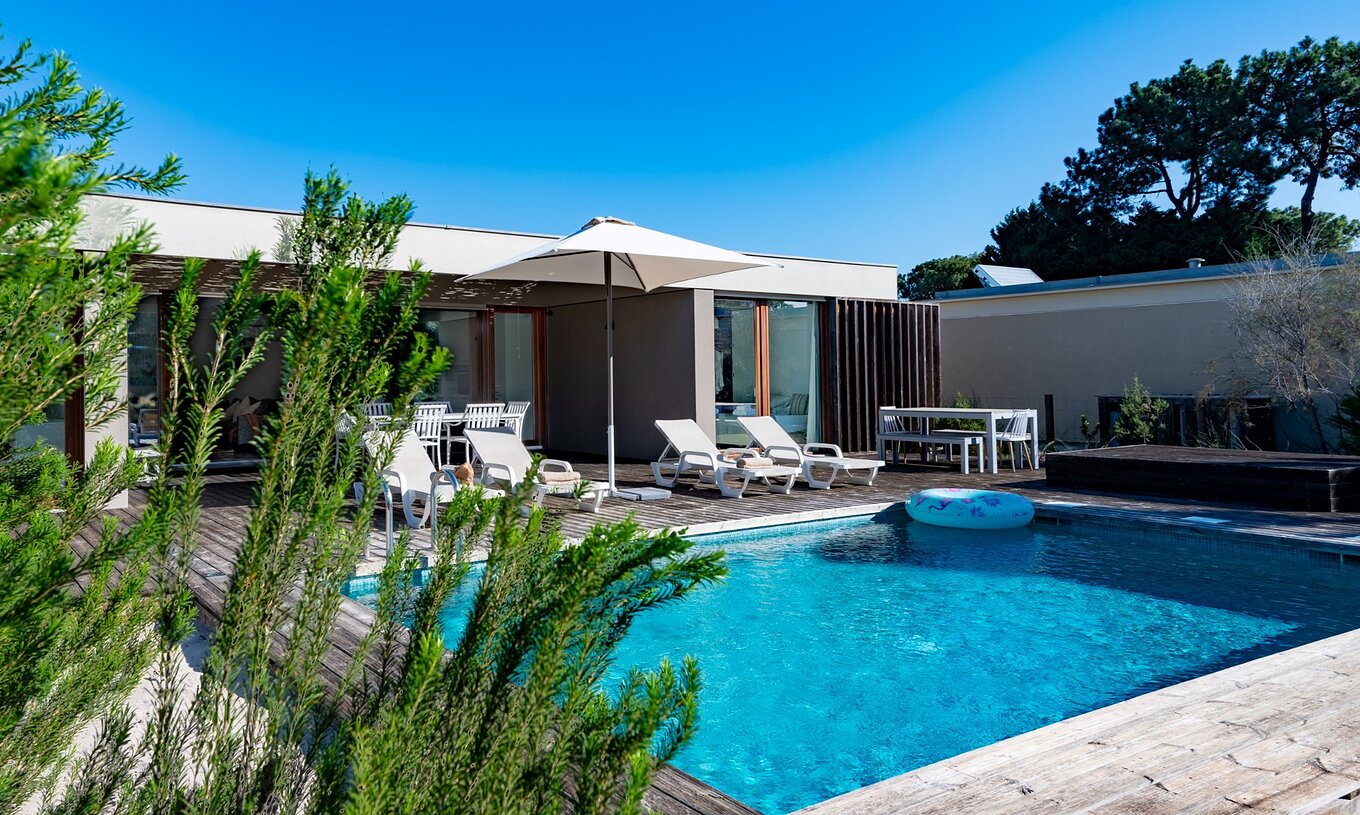 The 4-Bedroom Villas of Pestana Tróia Eco Resort have several sun loungers, a sun umbrella, and a float