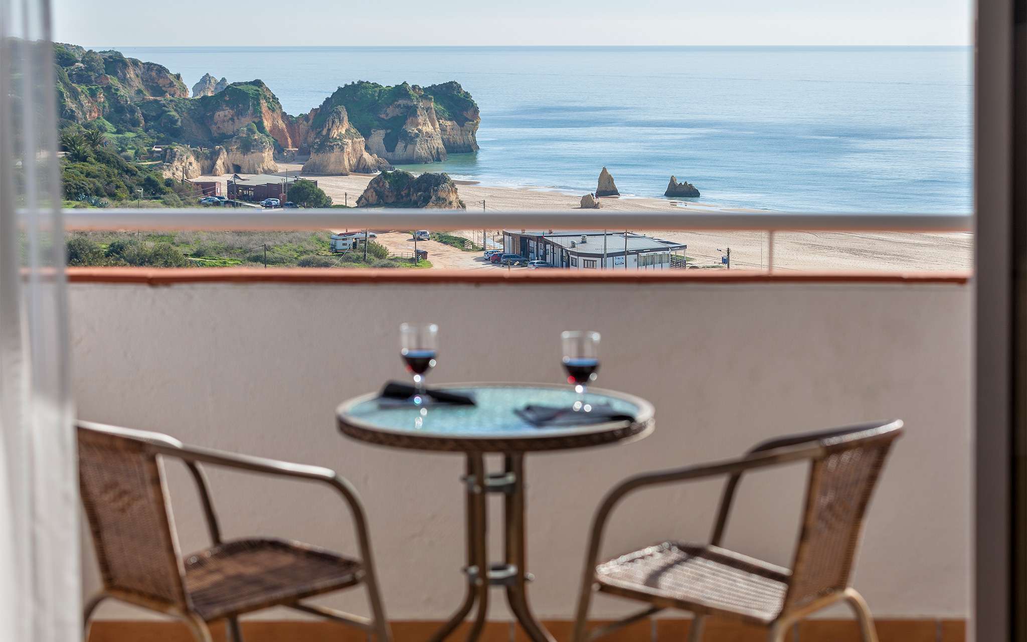 Table on a balcony with a beach view at Pestana Alvor Atlântico apartments