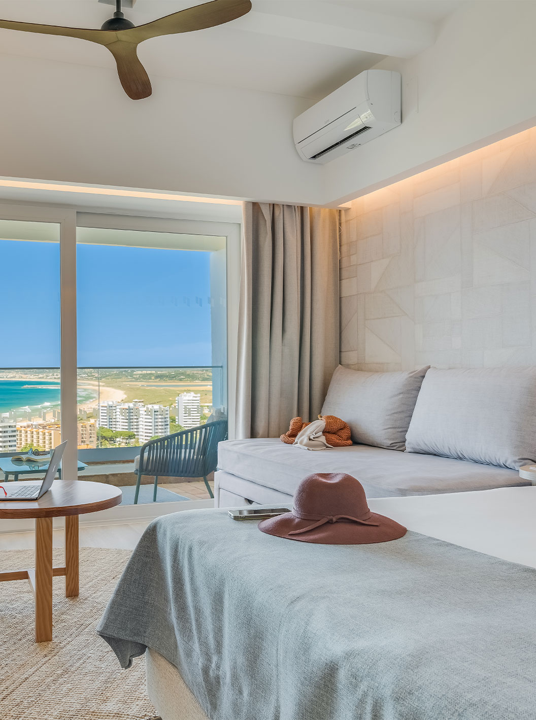 The Family Room at Pestana Blue Alvor Beach has a double bed, a sofa, and a balcony with a sea or garden view