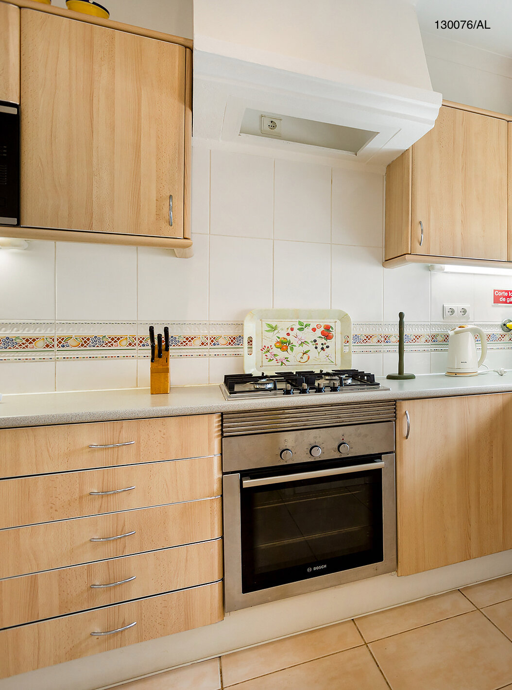 The Pestana Carvoeiro Golf T2 Standard Apartment has a kitchen equipped with wooden cabinets and appliances