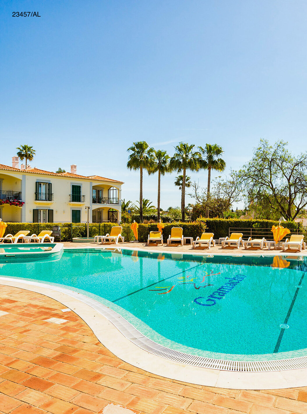 The Pestana Carvoeiro Golf T3 Standard Apartment has an exterior patio with a pool and yellow loungers