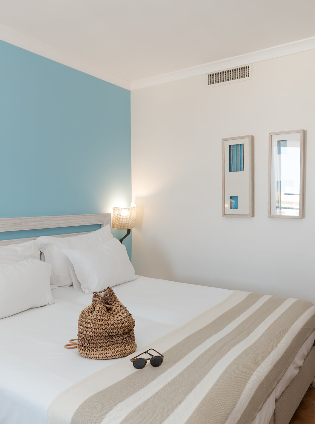 The Deluxe Side Sea View at Pestana Viking has two beds, bedside tables and two pictures on the wall