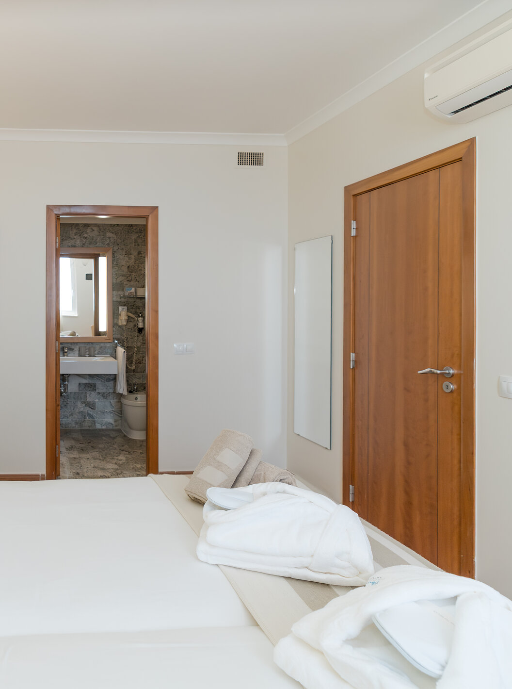 The Sea View Suite at Pestana Viking has two beds with bedside table and a bathroom