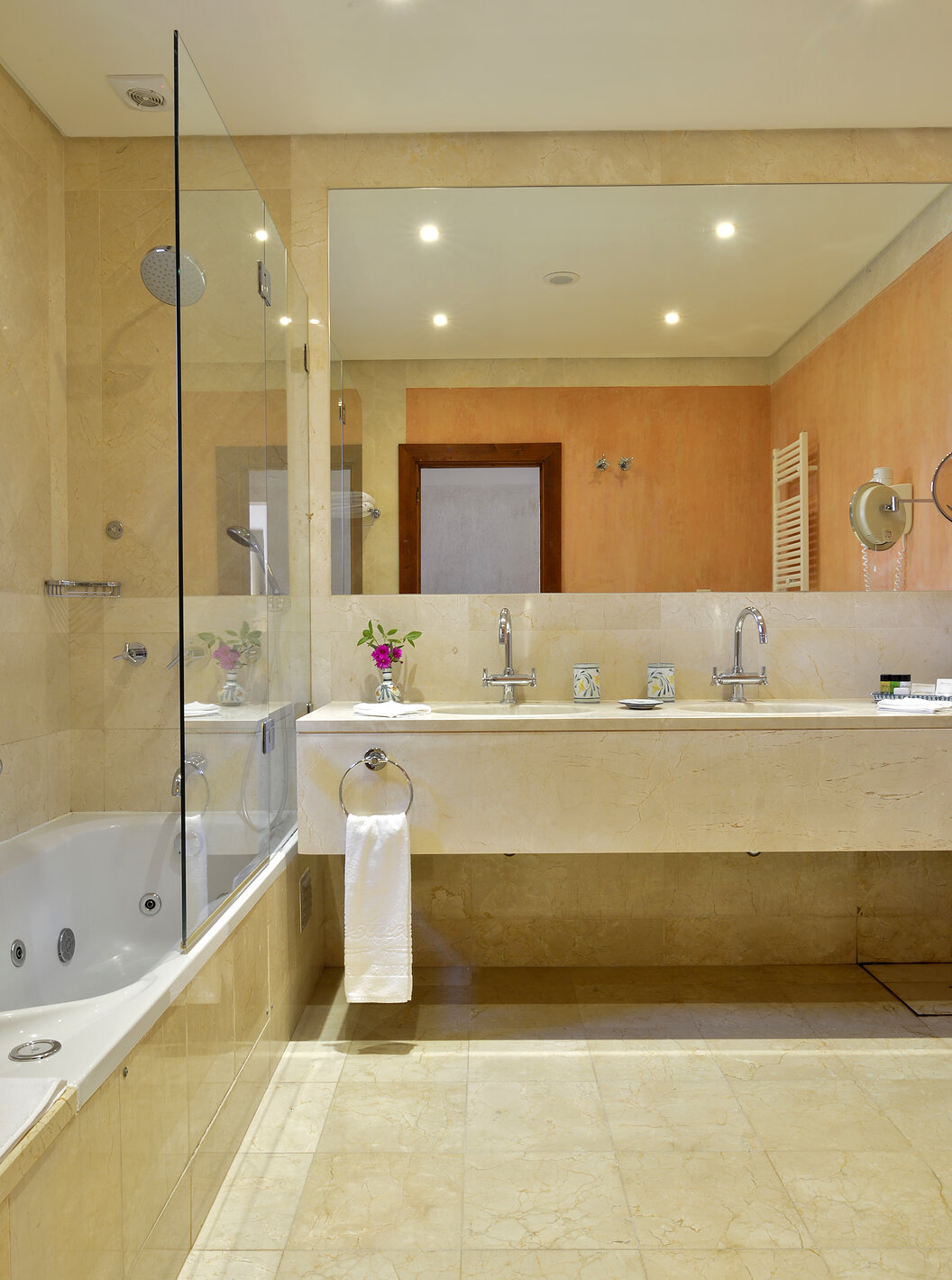 The Garden View Suite at Pestana Vila Sol - Vilamoura has a bathroom with a bathtub, two sinks, and a mirror