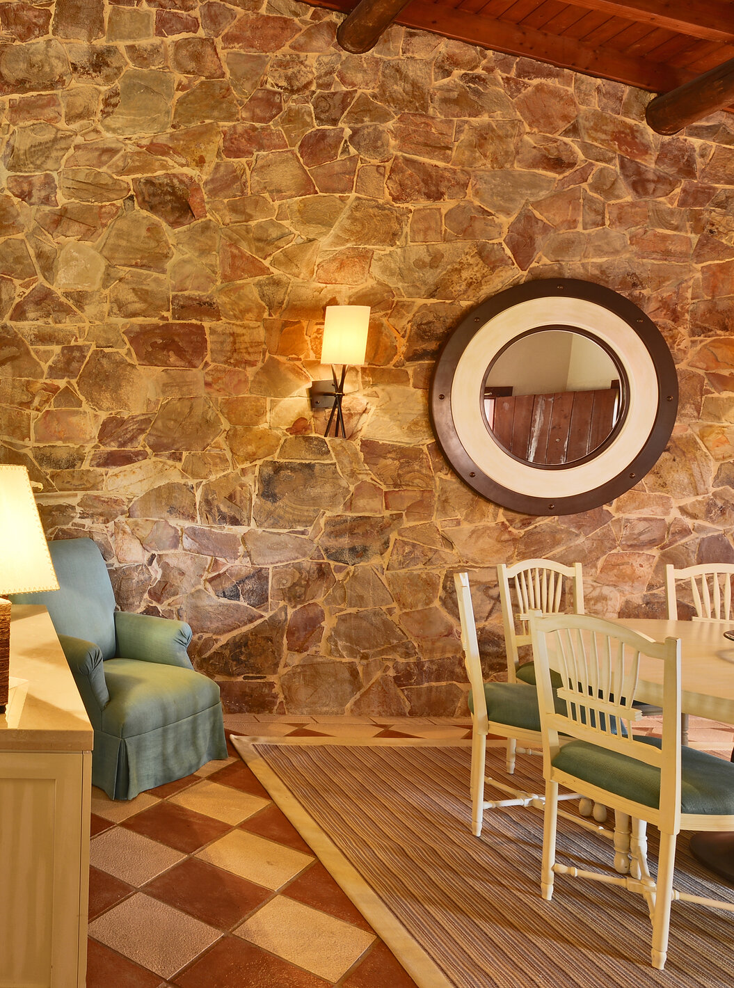 The Garden View Suite at Pestana Vila Sol - Vilamoura has a living room with a sofa, fireplace, and dining table