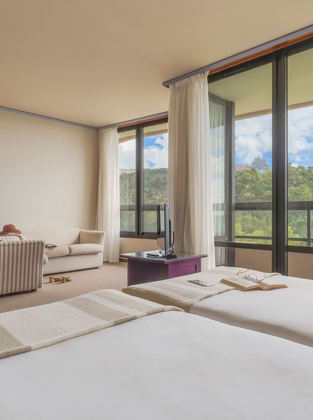 Junior Garden View Suite at Pestana Bahia Praia has a beautiful view of green landscapes, with access to the balcony