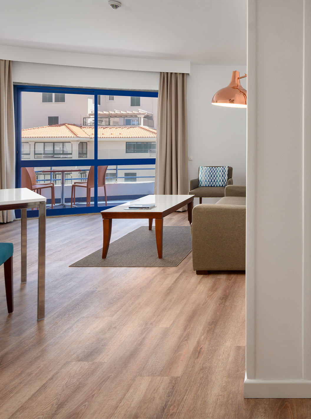 The Deluxe Sea View Suite at Pestana Cascais has a living room with a sofa, coffee table, and balcony