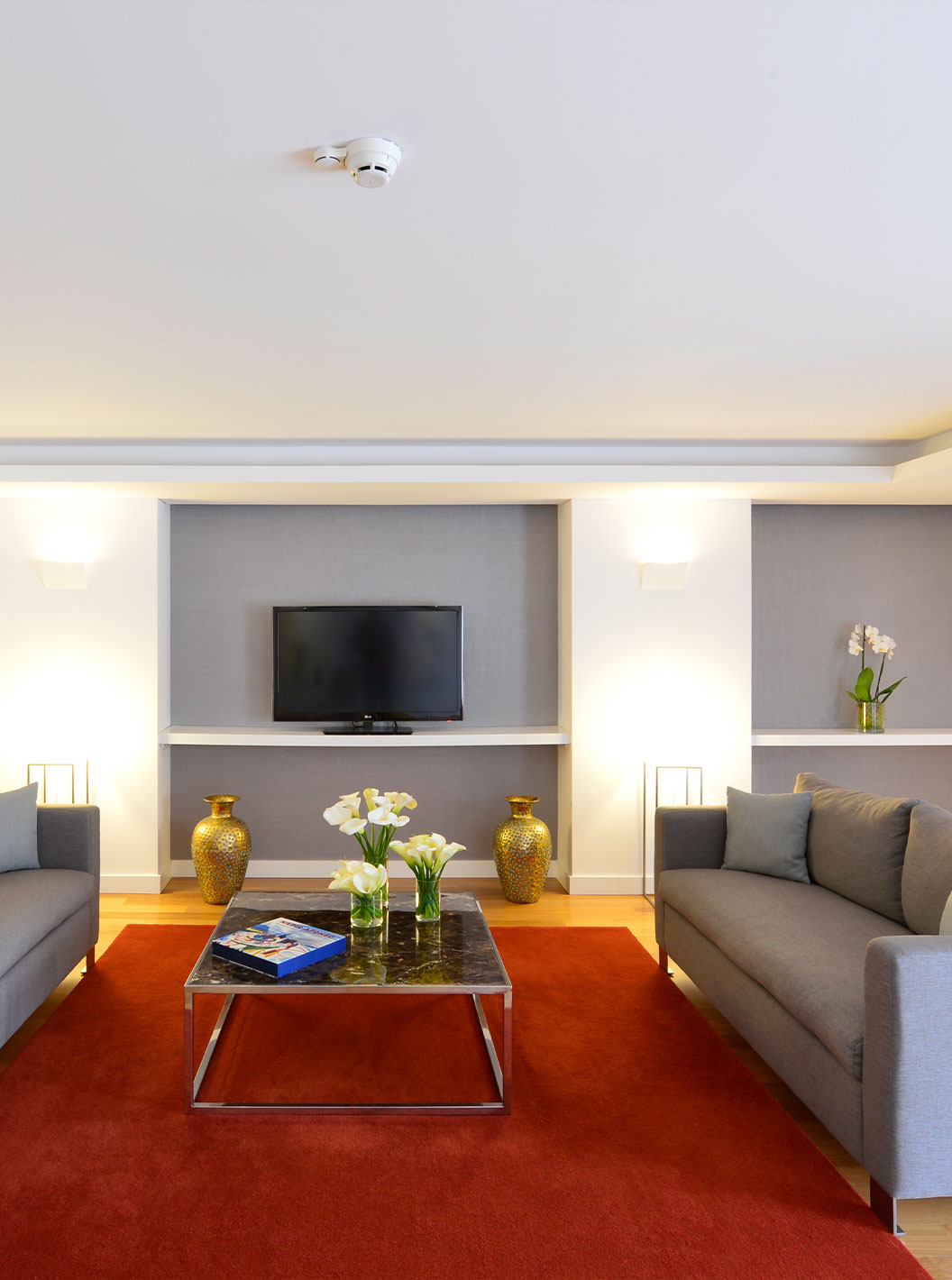 The Presidential Suite at Pestana Cidadela Cascais has a living room with two large sofas, a coffee table, and a TV