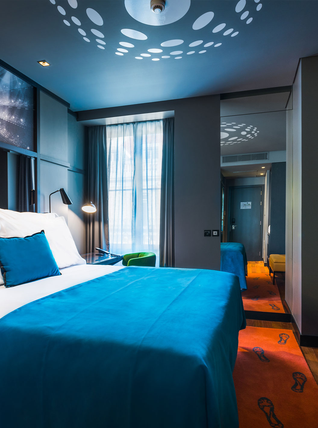 The CR7 Room at Pestana CR7 Lisboa includes a double bed, a mirror, and a desk