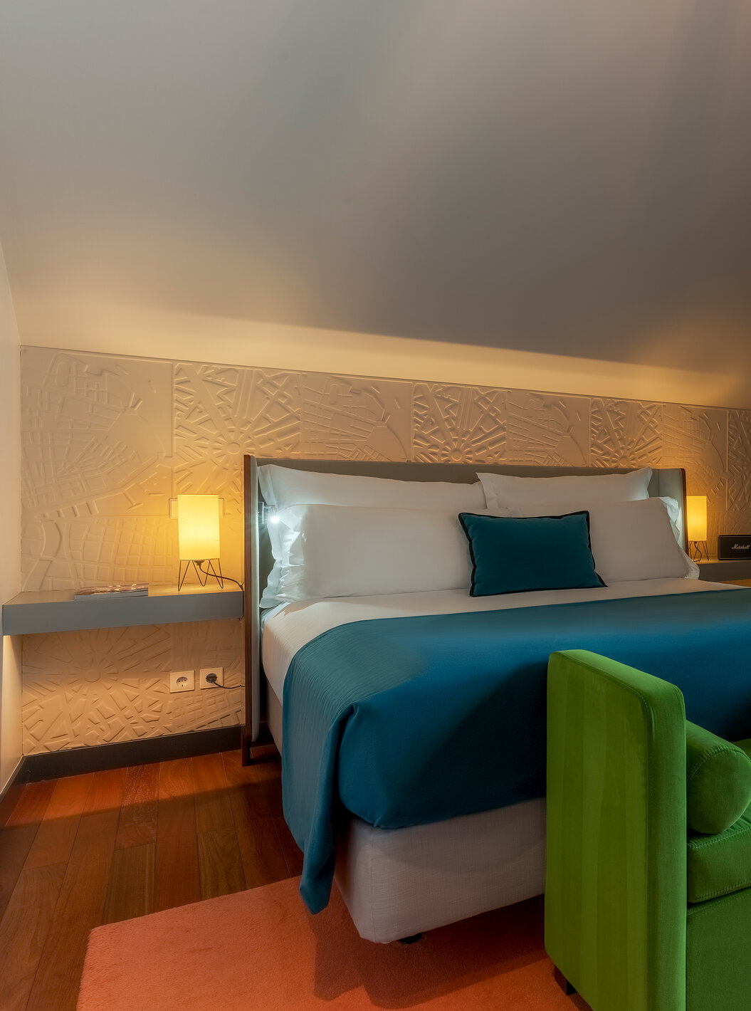 The CR7 Suite has a double bed a bench at the foot of the bed and a balcony at Pestana CR7 Lisbon