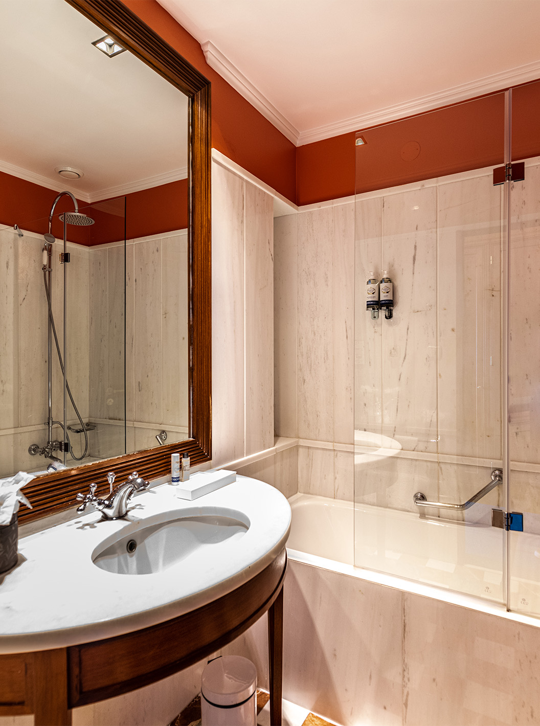 The Premium Garden room at Pestana Palace Lisbon features a bathroom with a bathtub, a marble and wood sink, and a mirror