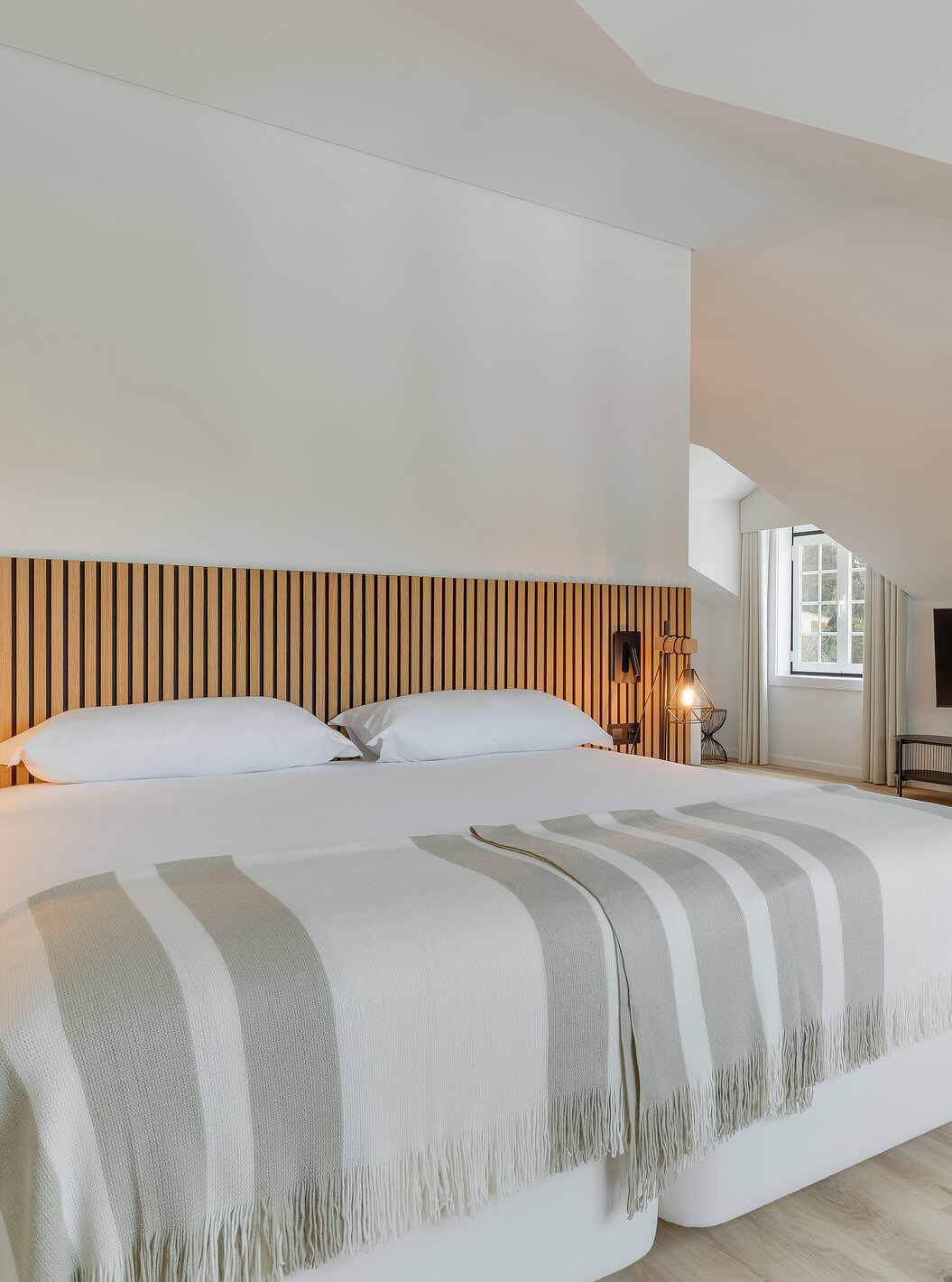 The Suite - Clubhouse of Pestana Sintra Golf has a double bed with wooden headboard, two chairs, and a television