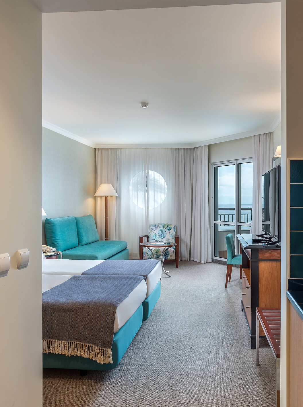 The Family Room at Pestana Grand has a kitchen with sink, two single beds and sofa