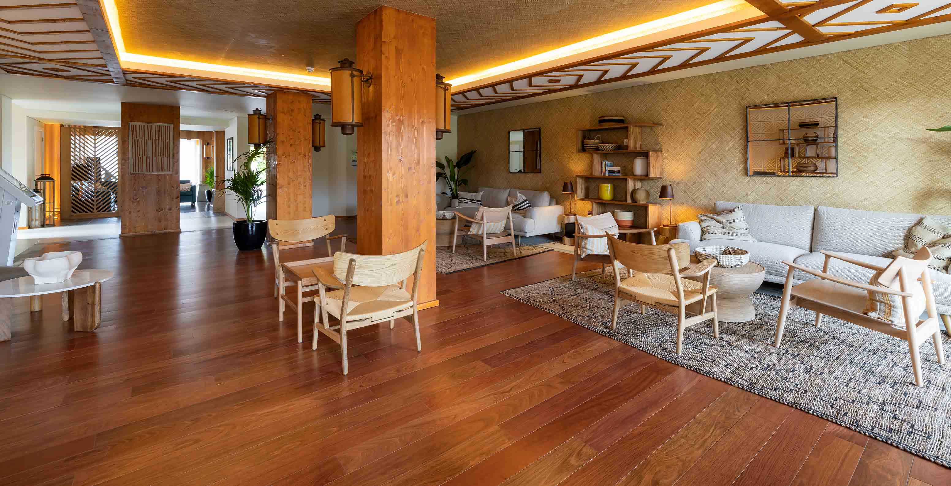 Spacious area with several sofas, armchairs, and wooden elements at Pestana Porto Santo