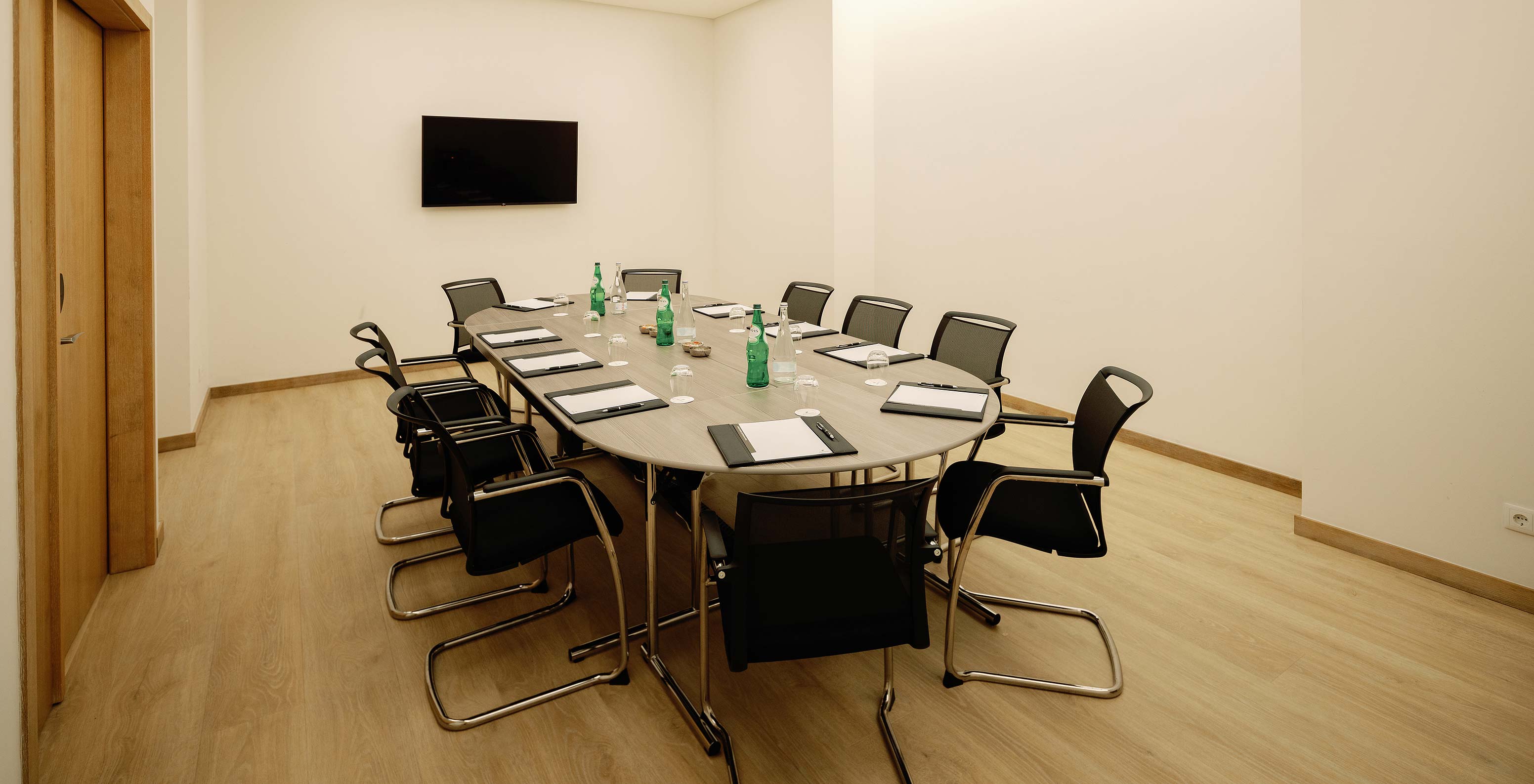 Douro VIII room with chairs a table and a screen at Pestana Douro Riverside Hotel with Pool by the Douro River
