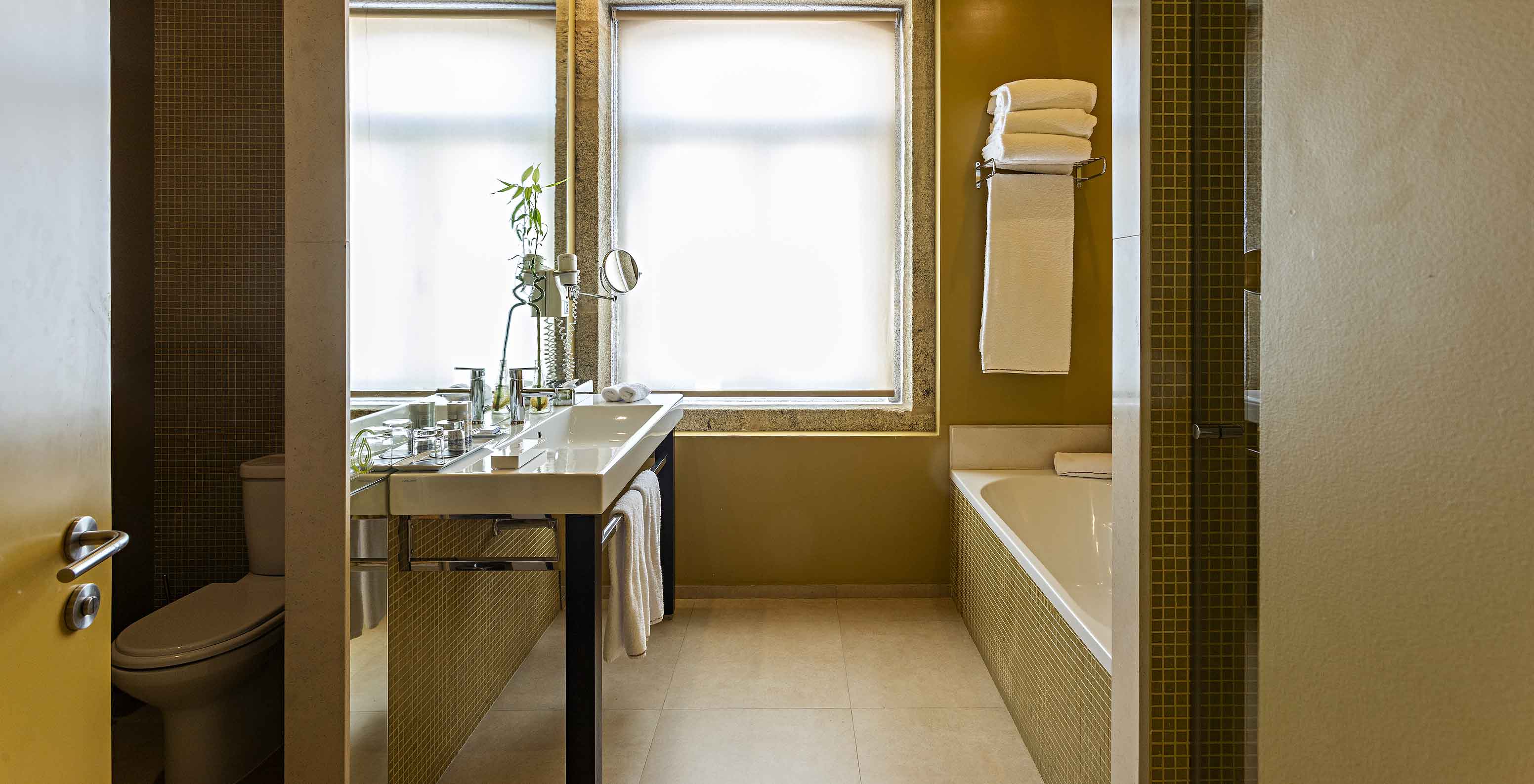 The Standard Suite has a bathroom with bathtub, sink, and separate toilet area