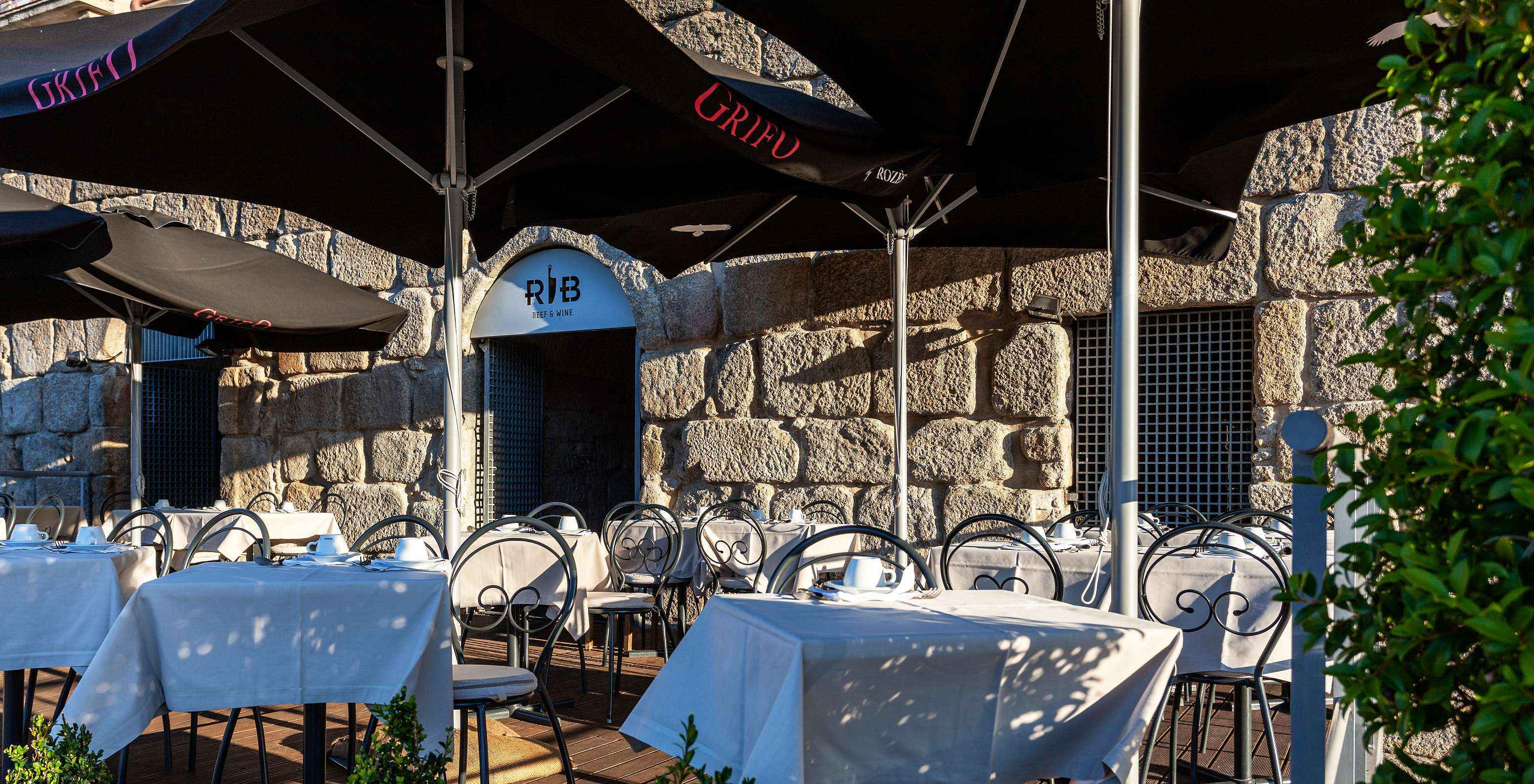 Outdoor terrace of the restaurant at Pestana Vintage Porto, a hotel at Praça da Ribeira in Porto