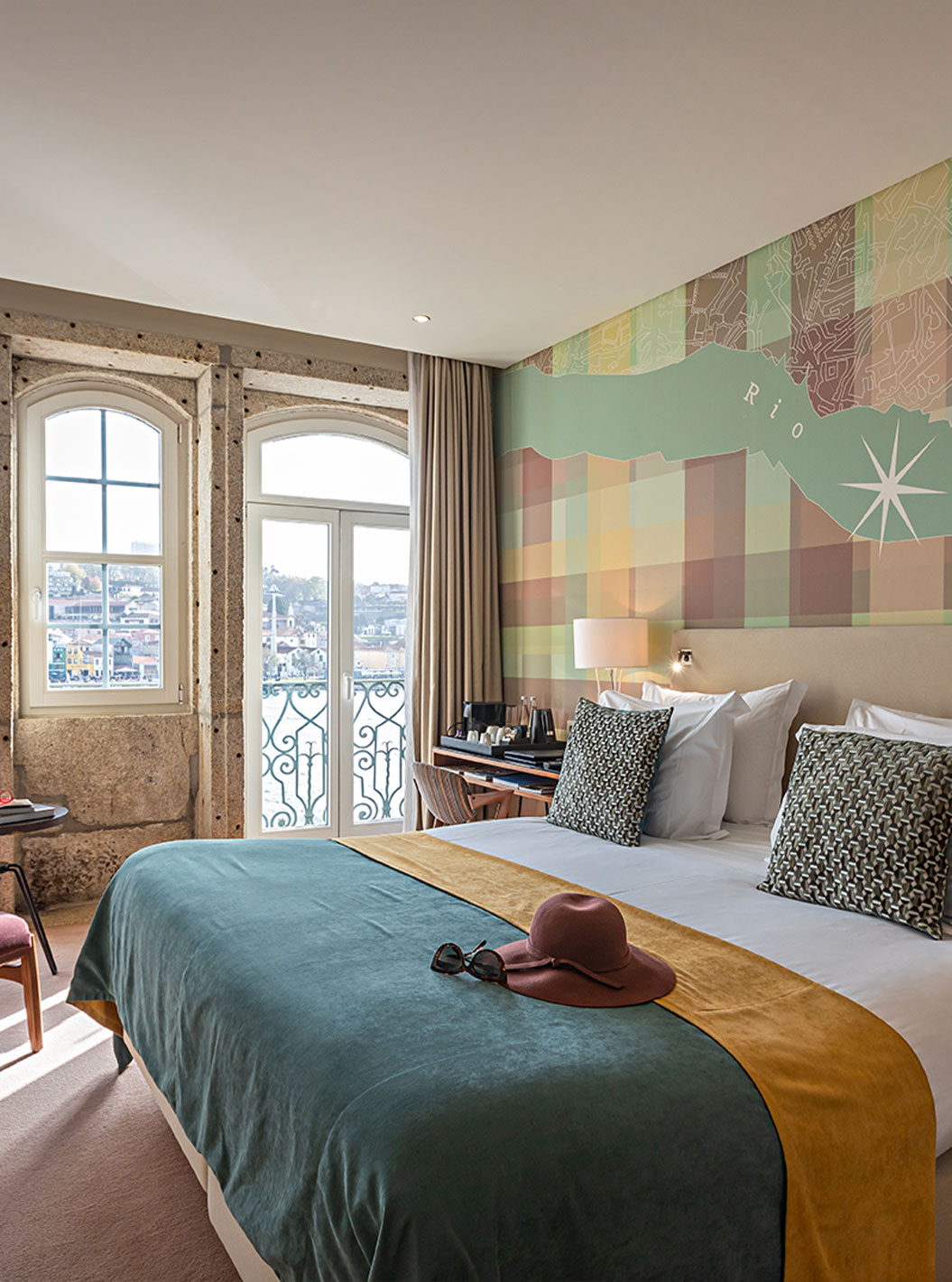 The Vintage River View Balcony at Pestana Vintage Porto has a double bed and large windows with a view of Porto