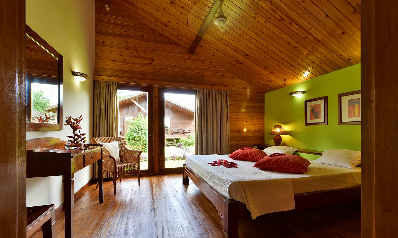 The Standard Double at Pestana Equador Ilheu das Rolas features a double bed, a chair, a window, and wooden floor and ceiling