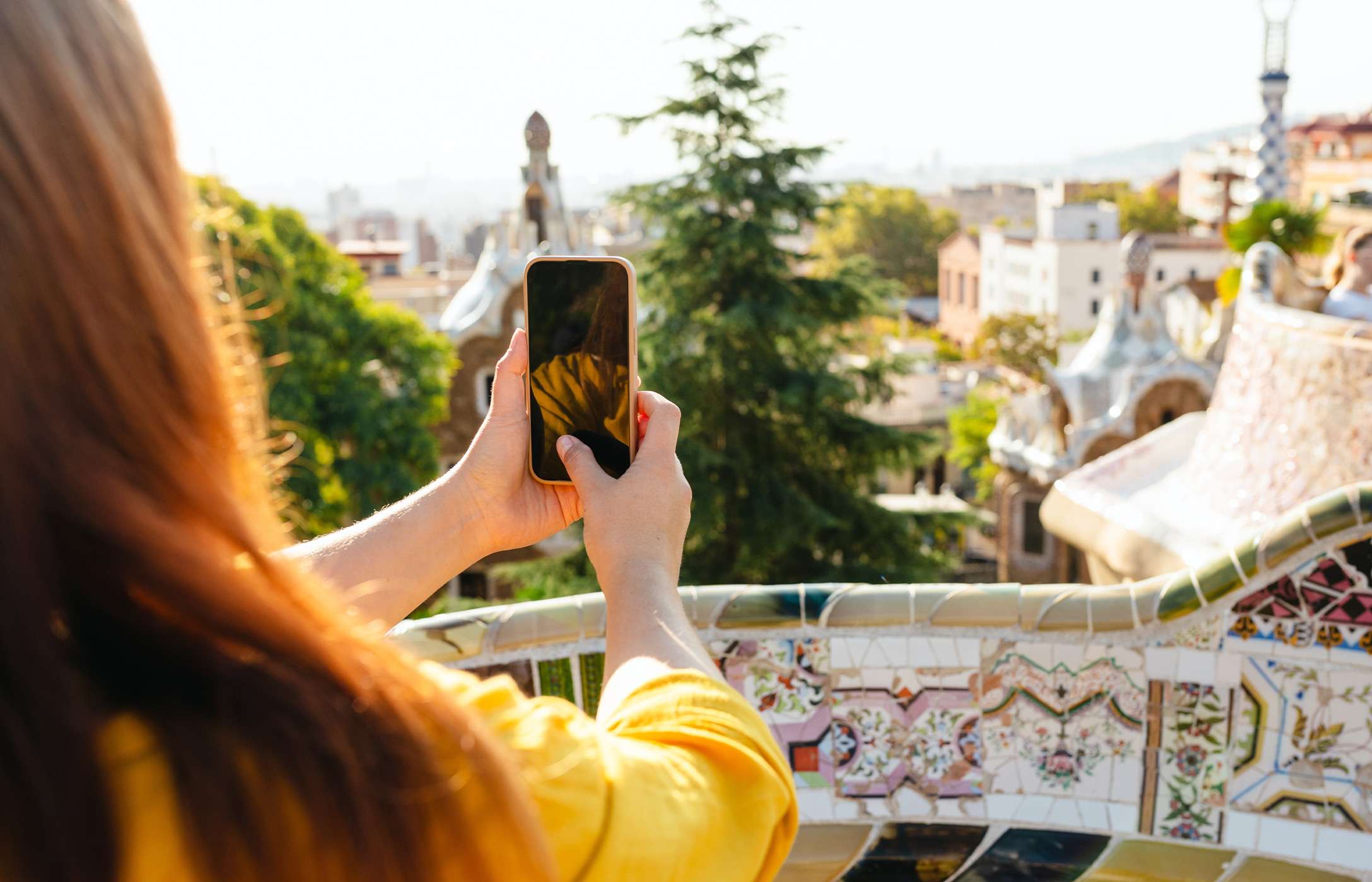 Person photographing the view of Barcelona at the famous Park Güell with their mobile phone