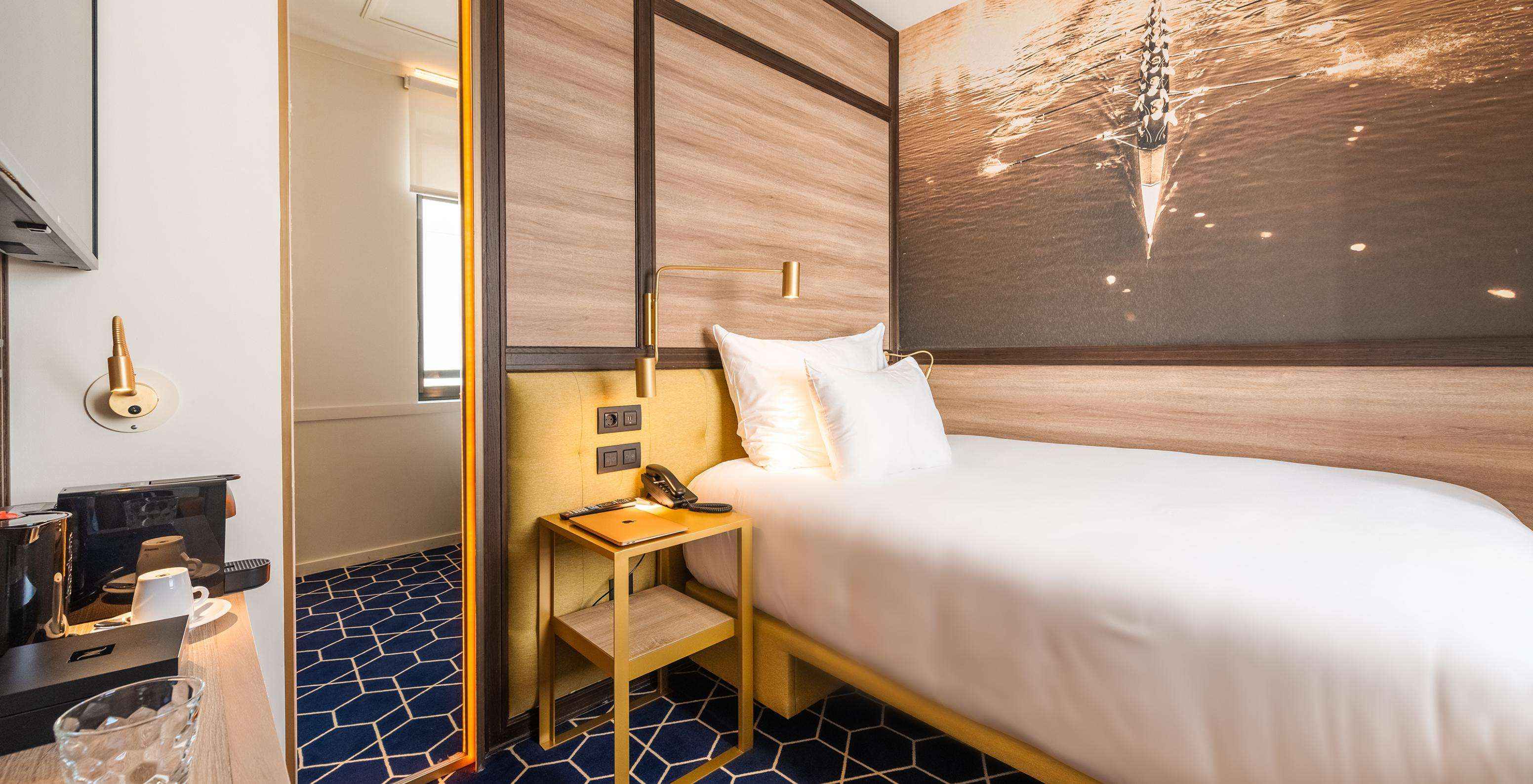 The Cozy Room at Pestana CR7 Gran Vía Madrid has a single bed, coffee machine, a mirror, and a window