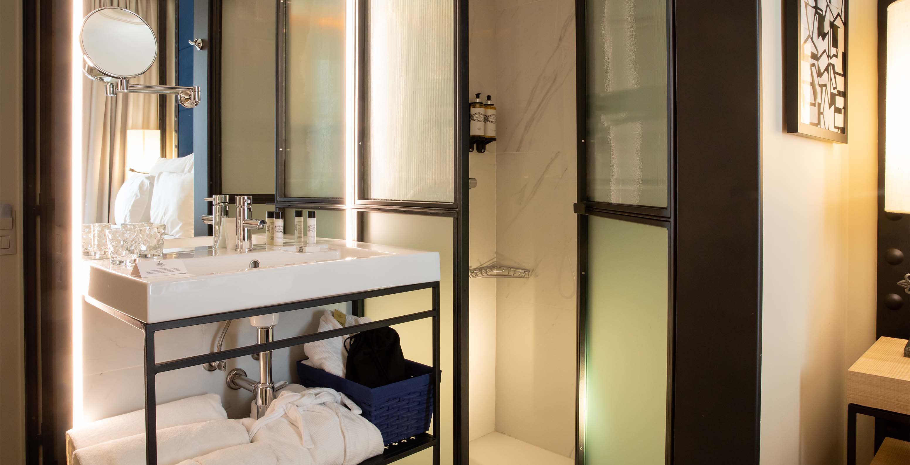 The Classic Room at Pestana Collection Plaza Mayor has a bathroom with sink with mirror, shower, towels and amenities