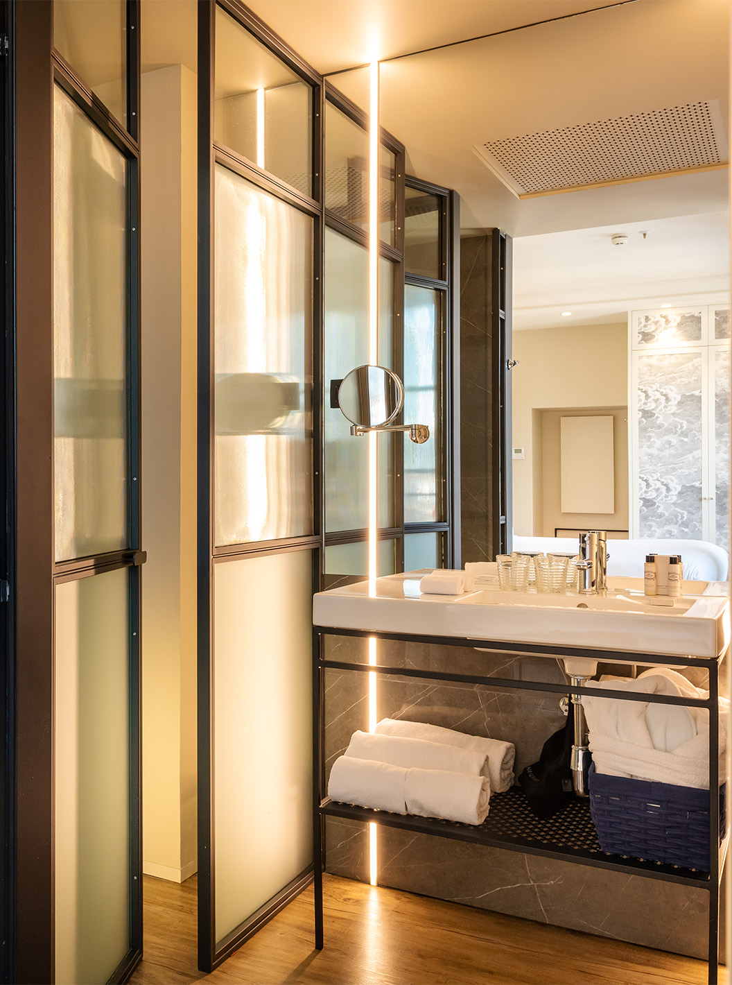 The Deluxe Grand Plaza Mayor at Pestana Plaza Mayor Madrid has a bathroom with sink with mirror and towels