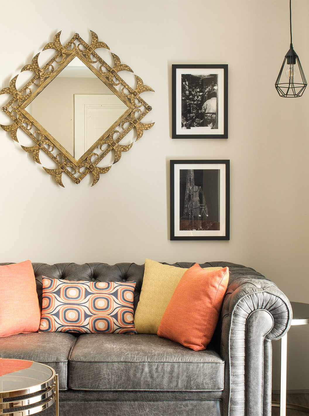 The Deluxe Grand Plaza Mayor at Pestana Plaza Mayor Madrid has a gray two-seater sofa and paintings on the wall