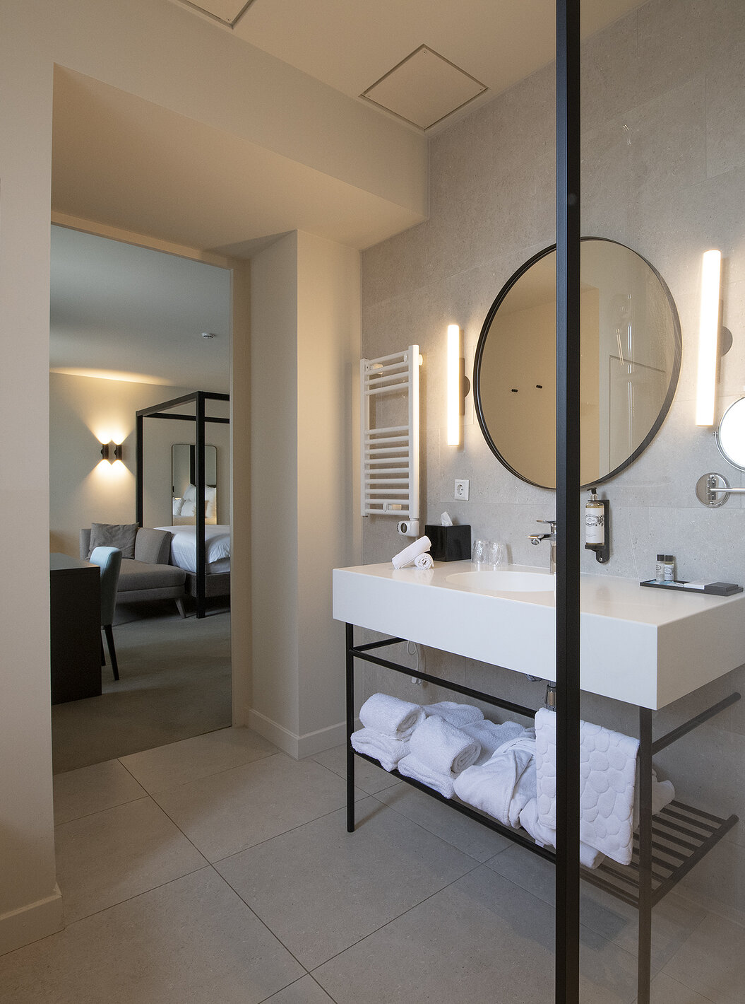 Premium Deluxe room at Pestana Amsterdam Riverside has a bathroom with mirror, sink, towels and shower