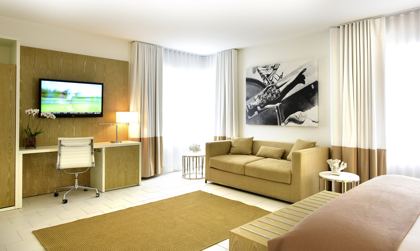 The Deluxe with Sofa Bed at Pestana Miami South Beach has a living room with sofa, desk and TV