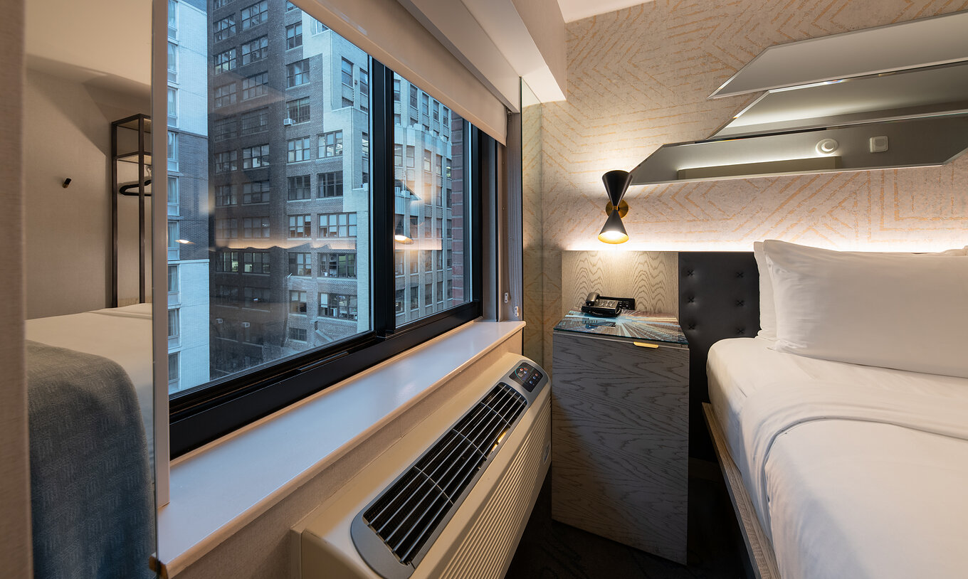 The Comfort Street View ADA at Pestana CR7 Times Square has a city view window next to the double bed