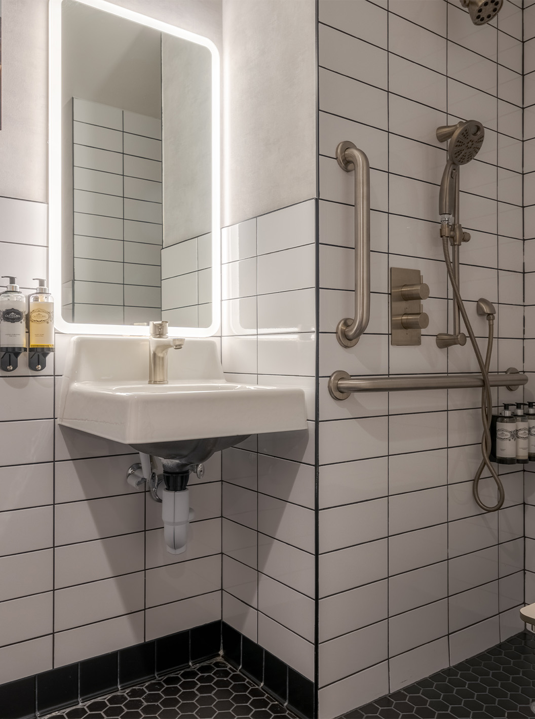 The Superior Double ADA at Pestana CR7 Times Square has an adapted bathroom with shower, sink, and mirror