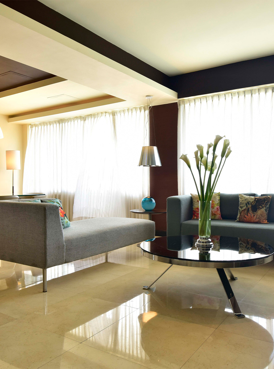 The Presidential Suite at Pestana Caracas has a spacious living room with three comfortable sofas and a dining table