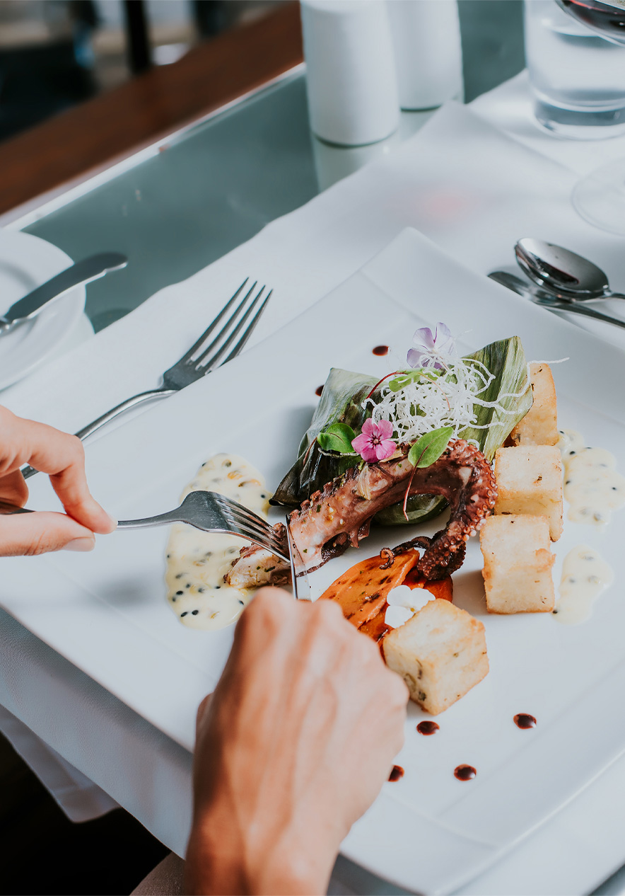 White plate with octopus and fried corn, during a meal at a Pestana Hotels and Resorts hotel