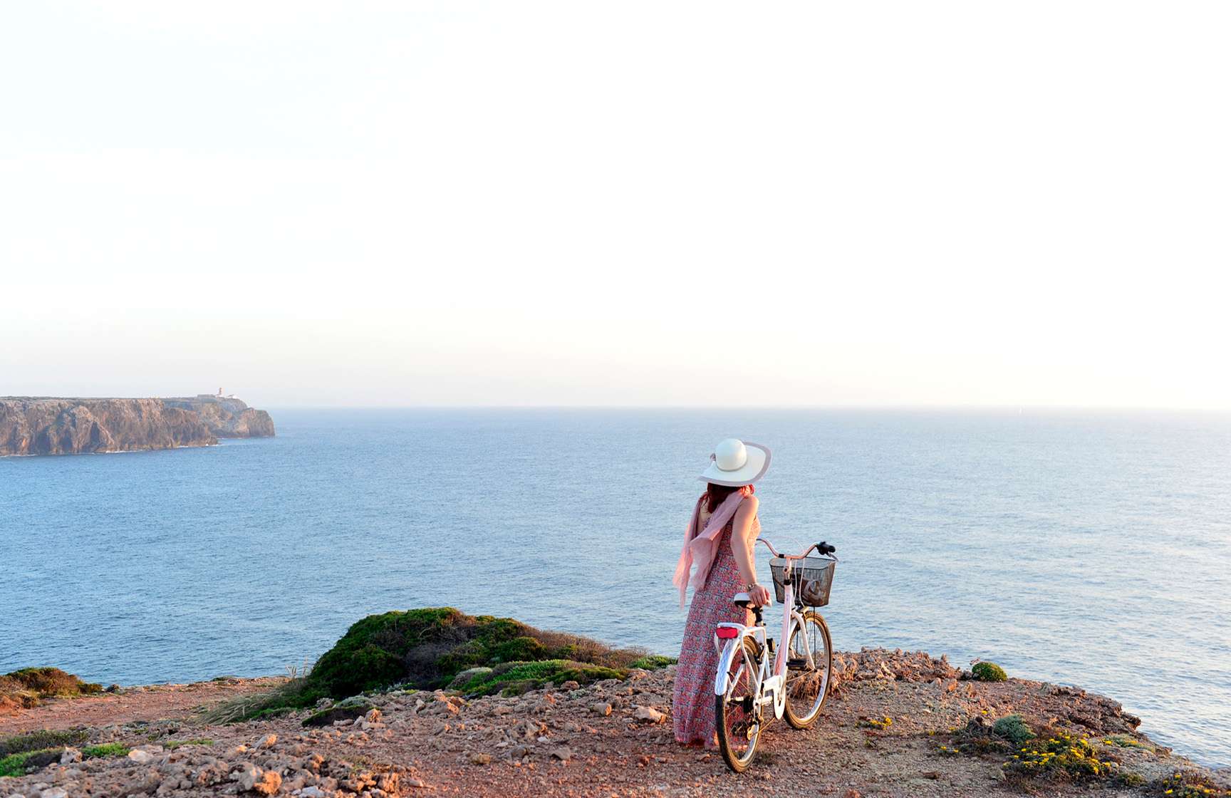 Woman cycling on a dirt road through the dunes, with a bicycle from Pousadas de Portugal