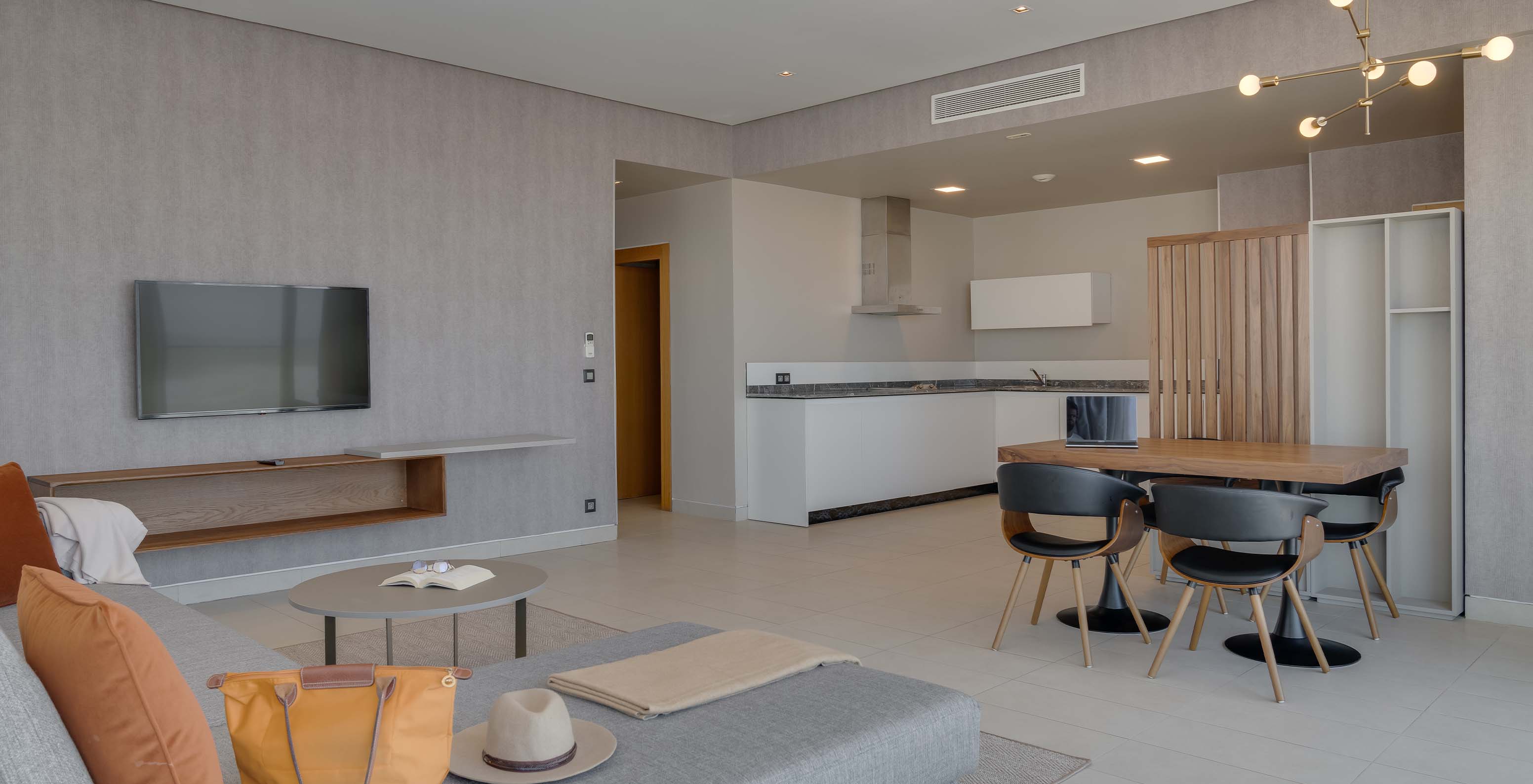 De Familiesuite Corniche van Pestana Casablanca heeft een ruime woonsuite met een bank, tv, eettafel en kitchenette.