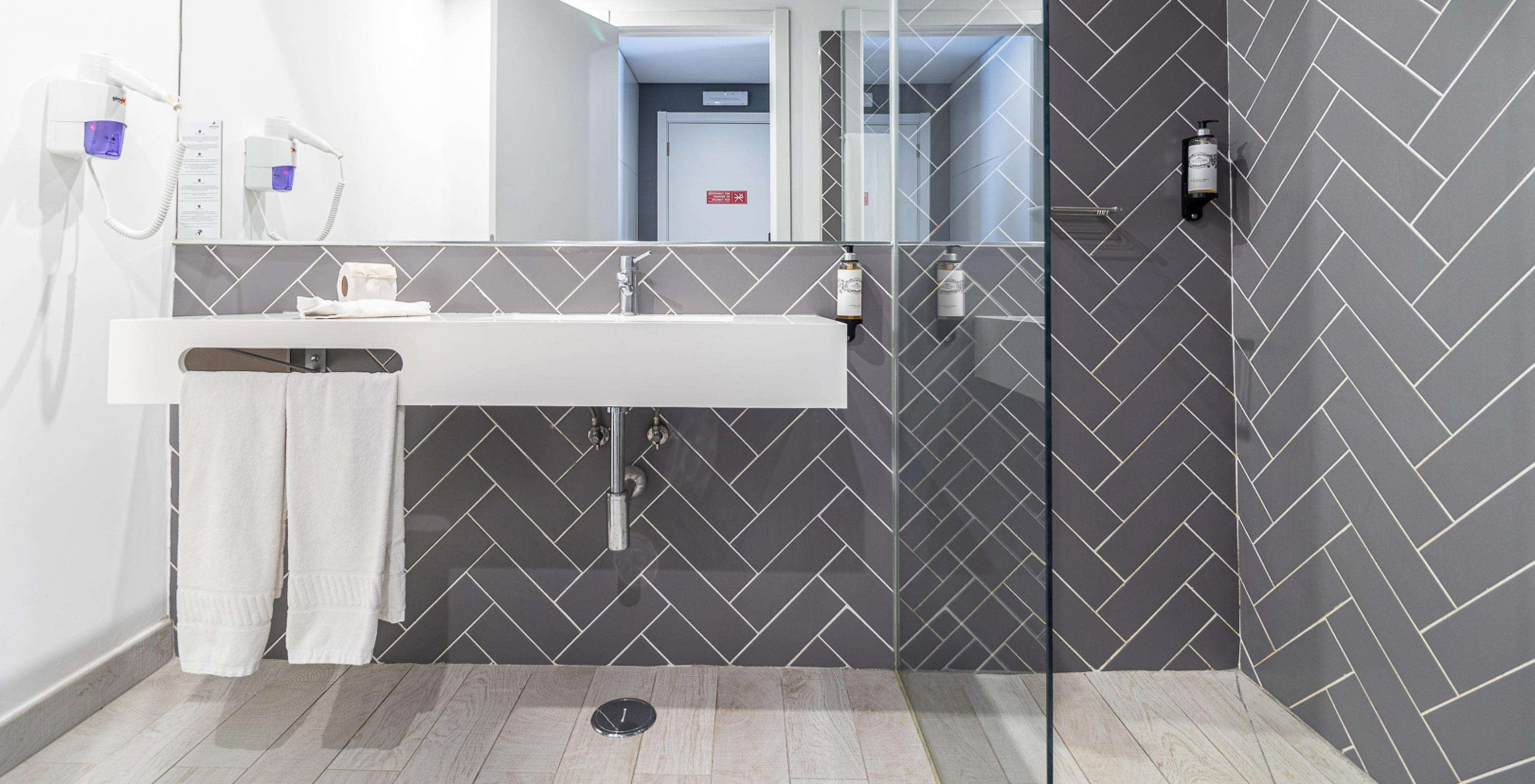 Klassieke kamer in Pestana Gramacho Residences met moderne badkamer, witte wastafel, spiegel en glazen douche