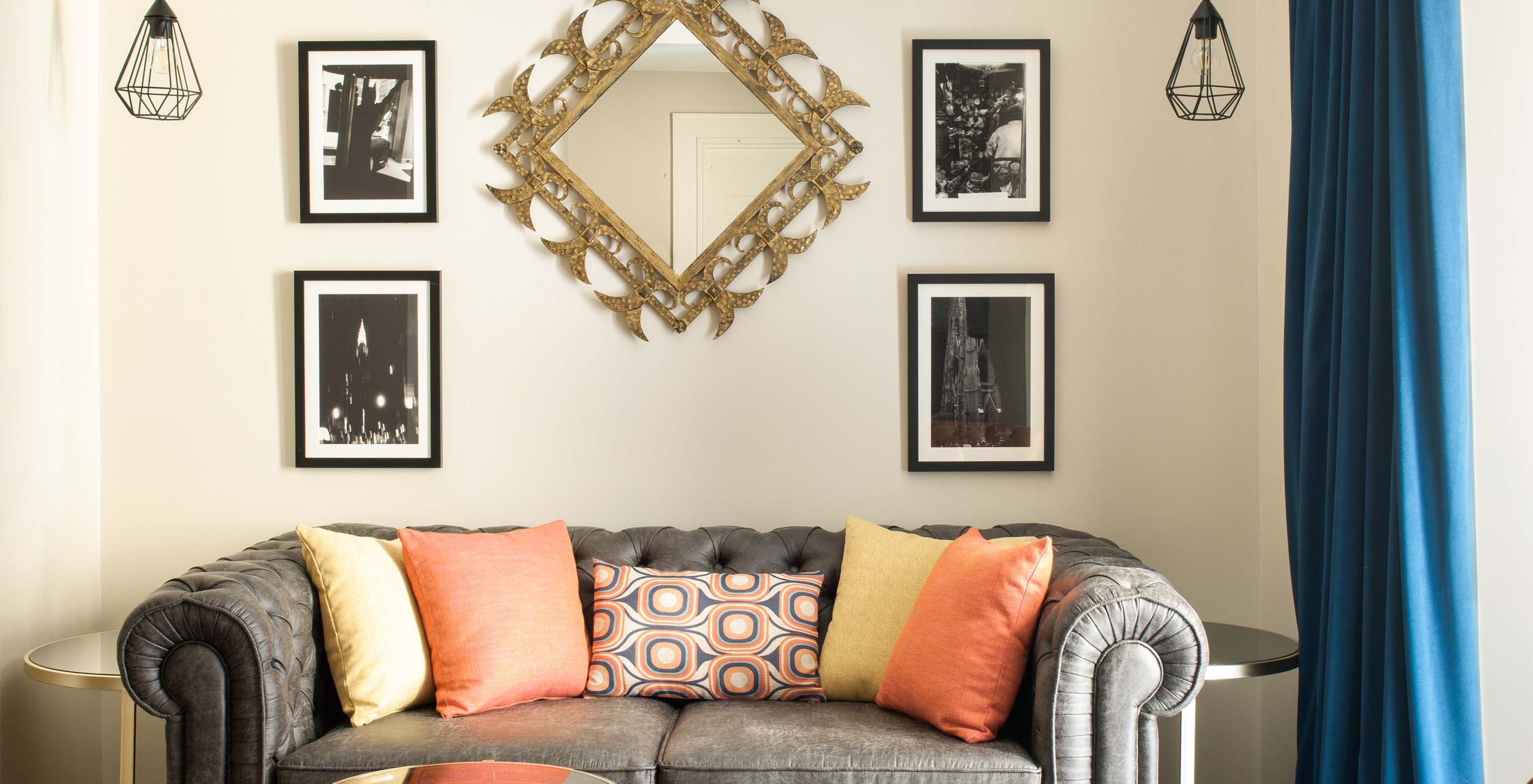 De Deluxe Grand Plaza Mayor van Pestana Collection Plaza Mayor heeft een grijze bank voor twee en schilderijen op de muur