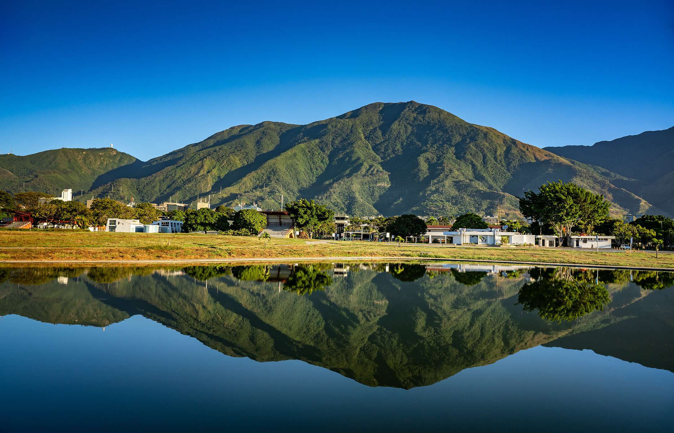 Vista panorâmica de uma montanha imponente refletida nas águas calmas de um lago em Caracas