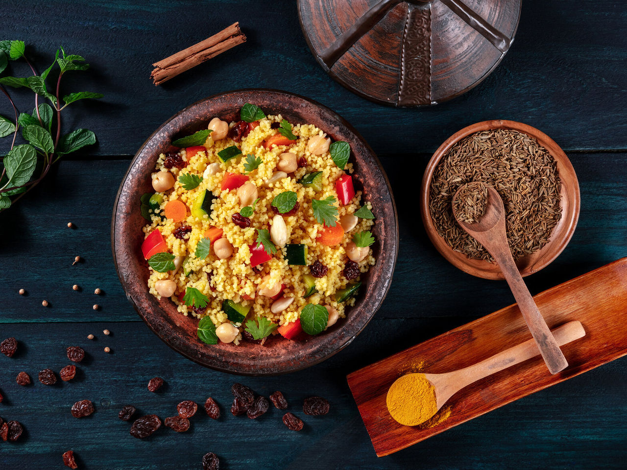Couscous, a typical dish you can eat in Casablanca, served in traditional pottery and accompanied by various spices