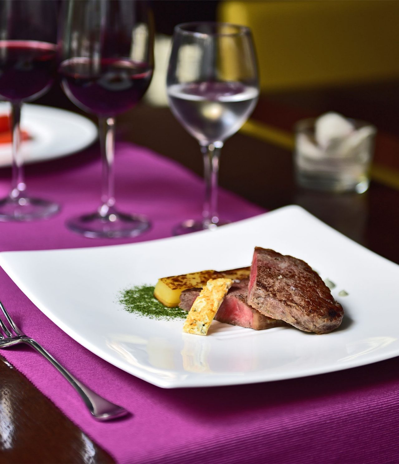 Lobby bar has an elegant plate with meat, fruit, wine, and water